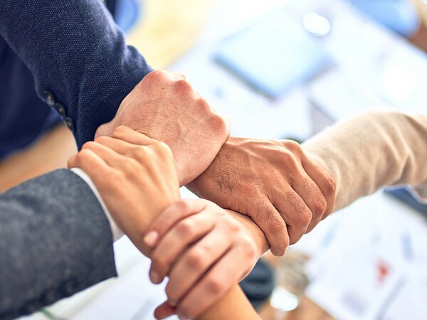 Multiple hands touching each other, forming a strong bond